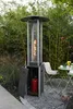 A patio heater is shown in an outdoor setting with bamboo in the background, a table and chairs nearby, and a gas tank inside the base. Produktbild-Vorschau
