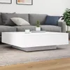A white coffee table with a gray base is placed on a rug in front of a gray sofa. Náhled obrázku produktu