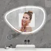 A woman is shown in a steamy bathroom, looking into a lighted mirror. Produktbild-Vorschau