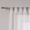 A close-up view of white sheer curtains hanging from a silver curtain rod. Produktbild-Vorschau