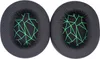 Two black ear pads with a green geometric pattern on a white background. Náhled obrázku produktu
