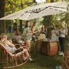 People enjoying an outdoor gathering under a large cantilever umbrella with solar LED lights. Náhled obrázku produktu