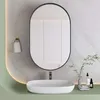 A modern bathroom vanity with a sink, faucet, and oval mirror. Podgląd zdjęcia produktu