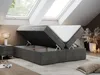A bedroom with skylights, featuring a dark gray boxspring bed with its storage compartment open. Produktbild-Vorschau