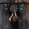 A young boy playing darts against a wooden wall. Náhľad obrázku produktu
