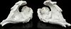 Two white angel figurines with pink floral accents, lying down with wings spread, against a black background. Produktbild-Vorschau