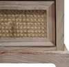 A close-up view of a wooden drawer with a rattan insert and a gold knob. Podgląd zdjęcia produktu