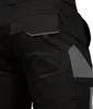 A close-up view of the back pockets and reflective detailing on a pair of black work shorts. Produktbild-Vorschau