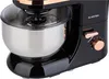 A close-up view of a black kitchen mixer with copper accents, showing the mixing bowl, whisk attachment, and control dial. Produktbild-Vorschau