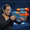 A young girl wearing safety glasses aims a Nerf Elite 2.0 Phoenix CS-6 blaster. Podgląd zdjęcia produktu