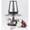 A food chopper with onions and garlic inside and around it. Produktbild-Vorschau