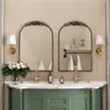 A bathroom vanity with two arched mirrors, sinks, faucets, and decorative elements. Podgląd zdjęcia produktu