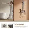 A woman is interacting with a shower control panel next to a bathtub, with a shower system visible on the right. Anteprima dell’immagine prodotto