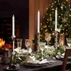 A festive table setting with LED candles, glasses, and a Christmas tree in the background. Produktbild-Vorschau