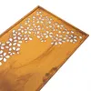 A close-up, angled view of a decorative metal panel with a floral cut-out pattern, set against a white background. Produktbild-Vorschau