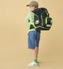 A young boy wearing a backpack and casual clothes, posing against a plain background. Náhled obrázku produktu