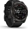 A close-up studio shot of a Garmin fenix 7X Sapphire Solar smartwatch with a black strap and a slate gray DLC titanium bezel. Produktbild-Vorschau