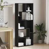 A black bookshelf filled with books and decorative items, placed next to a wooden desk and a plant. Náhled obrázku produktu