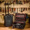 A workshop setting with tools hanging on the wall and two tool cases on a wooden surface. Produktbild-Vorschau
