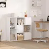 A white bookshelf with various items on display, including books, headphones, and boxes, in a room setting. Produktbild-Vorschau