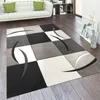 A modern living room with a sofa, bookshelf, and a rug. Anteprima dell’immagine prodotto