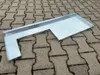 A galvanized metal tray with an L-shape, lying on a paved surface. Produktbild-Vorschau