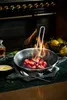 Strawberries being flambéed in a pan on a stovetop, with lemons and a bottle of liquid nearby. Náhľad obrázku produktu