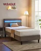 A bed with an upholstered headboard and integrated LED lighting, set up in a bedroom setting. Náhled obrázku produktu