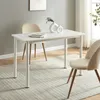 A white dining table with two chairs in a room with a grey wall and a window. Produktbild-Vorschau