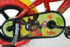 A close-up view of a child's bicycle chain guard, featuring cartoon characters and autumn leaves. Produktbild-Vorschau