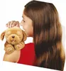 A young girl is holding a stuffed toy dog on her shoulder. Produktbild-Vorschau