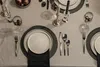 A formal table setting for a meal, with plates, cutlery, glasses, and candles. Náhľad obrázku produktu
