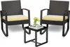 Two black rattan rocking chairs with yellow cushions and a small black table with a tray, two cups, and a vase of yellow tulips. Náhled obrázku produktu