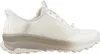 A side view of a white and tan Skechers Slip-Ins shoe against a white background. Produktbild-Vorschau