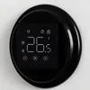 A close-up view of a black digital thermostat mounted on a white wall. Náhled obrázku produktu
