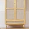A light wood wardrobe with rattan inserts on the doors and a drawer. Produktbild-Vorschau