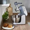 A kitchen counter with a food processor, a bowl, and some food. Produktbild-Vorschau