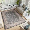 A living room scene with a rug, sofa, and coffee tables. Voir les images du produit