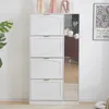 A white shoe cabinet with four flip-down doors and a full-length mirror on the side. Decorative vases and a framed poster are visible on top of and next to the cabinet. Produktbild-Vorschau