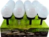 A display box of solar garden lights, with the lights arranged in rows on a green, grassy surface. Produktbild-Vorschau