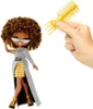 A doll is shown standing with a comb held by a hand. Náhľad obrázku produktu