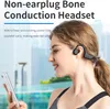 A woman wearing a bone conduction headset and looking at her phone. Podgląd zdjęcia produktu
