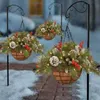 Three hanging Christmas baskets filled with pine branches, pinecones, and red berries, displayed outdoors in the snow. Anteprima dell’immagine prodotto