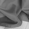 A close-up view of a gray fabric, likely a curtain, with visible stitching along the hem. Produktbild-Vorschau