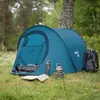A camping tent set up in a grassy, wooded area with camping gear nearby. Anteprima dell’immagine prodotto