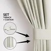 A close-up view of a cream-colored curtain with a tieback, showing how it is used to hold the curtain in place. Podgląd zdjęcia produktu