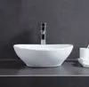 A white oval washbasin with a chrome faucet is shown on a dark countertop against a dark gray tiled wall. Produktbild-Vorschau