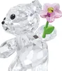 A crystal bear figurine holding a pink flower. Produktbild-Vorschau