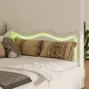 A close-up view of a bed with a headboard featuring LED lighting. Anteprima dell’immagine prodotto