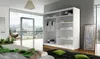 A modern bedroom with a large window overlooking a city, featuring a white wardrobe filled with clothes and shelves. Náhľad obrázku produktu